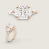 2.5ct Emerald Cut Center with 2 Trillion Cut stones of 1.1ct on the sides. Center stone size: 9x7mm     17668-CZ-14K