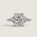 9ct Emerald Cut Center with 1.1ct Trillion Cut stones on the sides. Center stone size: 12x8.5mm 17161T-CZ-14K