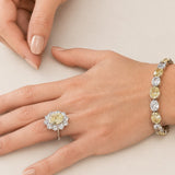 4.5ct Oval Cut Center surrounded by 12 Round Cut Stones of 2.5 TCW. Center stone size: 12x10mm F233-CAN-CZ-14K
